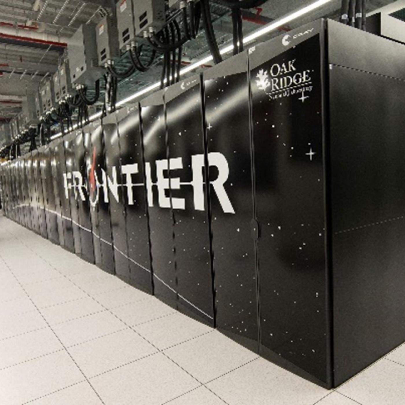 Image of the Frontier supercomputer in black with Frontier spelled out across the cabinets in front. 